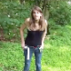 An attractive girl is recorded pissing and shitting in an outdoor location. Her product is shown hidden among the vegetation. Over a minute.